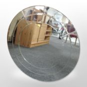 A circular bevelled frameless mirror, diameter 80cm.