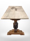 A heavily carved oak refectory table base with later plank top, 153cm long x 73cm wide x 75cm high.