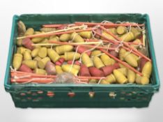 A large quantity of painted wooden spinning tops.