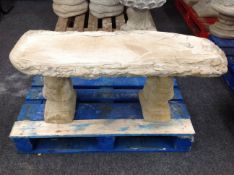 A rustic concrete garden bench on squirrel pedestal,