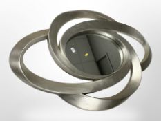 A contemporary overmantle mirror in swept silver frame, 123cm x 85cm.