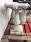 A concrete hexagonal bird bath,