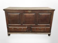 A George III panelled oak mule chest, 150cm wide x 59cm deep x 91cm high.