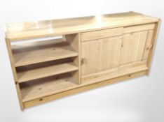 A late-20th century pine sliding door low sideboard, 145cm wide x 46cm deep x 76cm high.