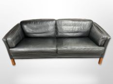 A late 20th-century Danish black leather two-seater settee, length 195cm x depth 80cm x 72cm.
