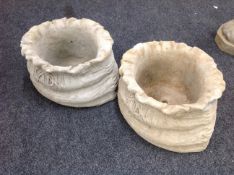 A pair of concrete sack planters,