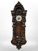 An impressive Victorian-style carved wall clock, length 145cm.