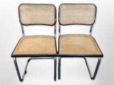 A pair of chrome-framed ebonised cantilever chairs with bergere seats.