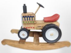 A child's painted wooden rocking tractor seat