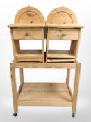 A pine two-tier trolley on castors, width 78cm, and a pair of bedside stands.