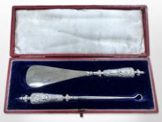 A silver mounted shoe horn and hook in fitted case, Birmingham 1898.