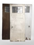 Three early-20th century doors with stained glass panels.