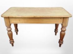 An early-20th-century pine rectangular table with tooled leather-inset writing surface,