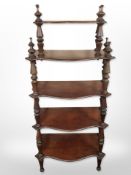 A Victorian mahogany five-tier serpentine-front whatnot stand, 136cm high.