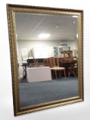 An ornate contemporary gilt overmantle mirror, 107cm x 137cm.