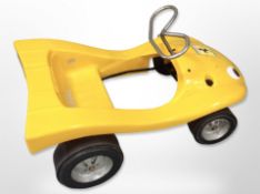 A child's ride-on Ferrari car.