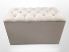 A contemporary storage ottoman in buttoned upholstery, width 91cm.