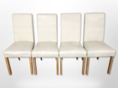 A set of four contemporary cream stitched leather dining chairs.
