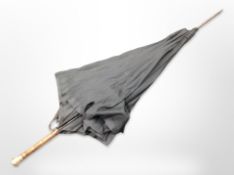 An early-20th century parasol with 9ct gold-plated pommel.