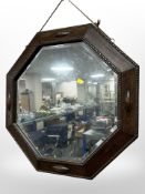 An Edwardian carved oak octagonal mirror, width 58cm.