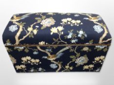An upholstered ottoman in floral fabric, width 88cm.