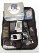 A group of vintage and later mobile phones, portable stereo radio, etc.