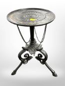 A 19th century painted cast iron tripod table,