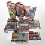 Nine Hasbro Transformers figurines, boxed.