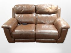 A contemporary brown stitched leather electric reclining two seater settee, with lead,