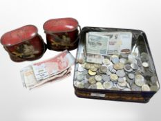 A tin of mixed coins and banknotes, a further pair of tins depicting cats.