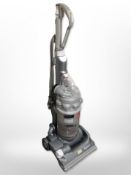 A Dyson upright vacuum cleaner.