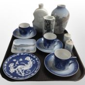 A group of Royal Copenhagen porcelain collector's plates, three teacups and saucers,