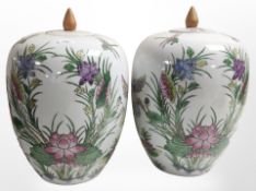 A pair of 20th-century Chinese export porcelain bulbous lidded jars, height 31cm.