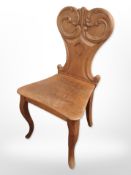 A Victorian carved oak hall chair