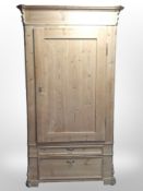 A 19th-century stripped pine hall cupboard, fitted drawers beneath,