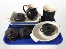 Nine pieces of Le Creuset enamelled pottery kitchen wares.