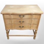 A 20th century Danish oak serpentine front three drawer chest,