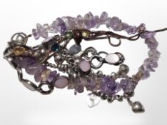 Two silver bracelets together with an amethyst chip bracelet, and one other bracelet.