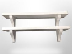 A pair of white painted book shelves, width 100cm.
