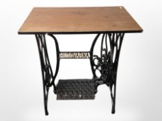 A cast-iron Husqvarna treadle sewing machine base with plywood top, width 71cm.