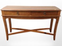 A reproduction yew wood console table, fitted two drawers,