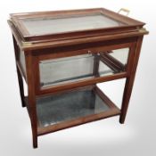 A glazed mahogany display table with lift-off twin-handled tray top,