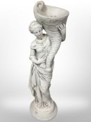 A composition garden statue of a lady holding a cornucopia, height 79cm.