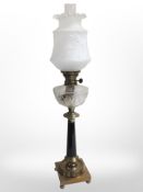 A brass and glass oil lamp with frosted glass shade, height 80 cm,