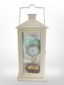 A decorative Fabergé-style quartz timepiece, together with a metal lantern.