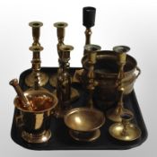 A group of brass candlesticks, mortar and pestle, jardiniere, etc.