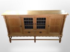 A Danish blonde oak sideboard with leaded glass doors, 205cm wide x 47cm deep x 115cm high.