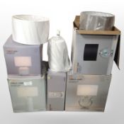 A group of modern table lamps, in boxes.