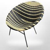A 20th century wicker chair on metal legs