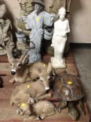 Seven assorted garden ornaments including tortoise, ceramic figure of an owl, oriental statue, etc.